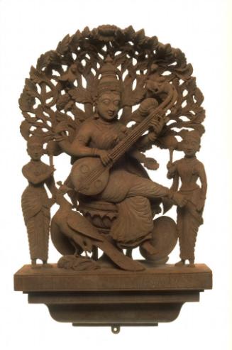 The Hindu deity Sarasvati playing the lute, with attendants and peacock