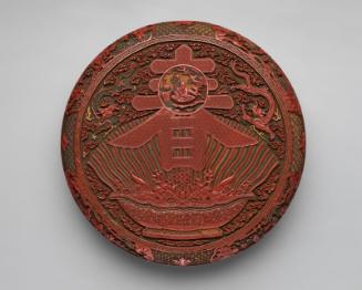 Circular box decorated with the character for spring and a bowl of treasures
