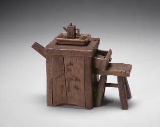 Teapot in the shape of a tea crate and stool