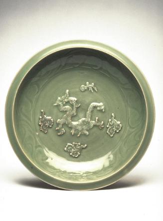 Plate with applied dragon amid clouds
