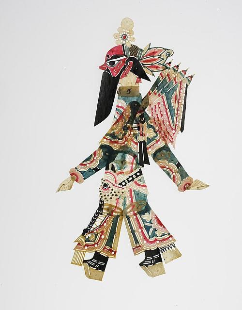 Red-faced man with black beard wearing lotus headdress and banners