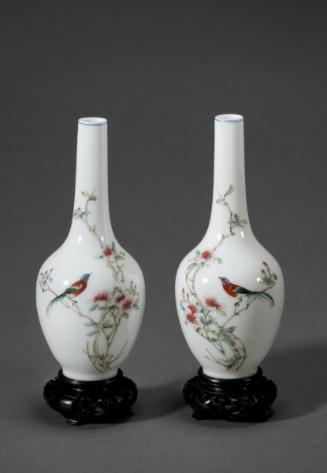 Vase with bird on blossoming branch