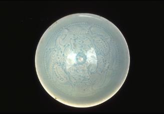 Bowl depicting two boys playing amid lotus scrolls