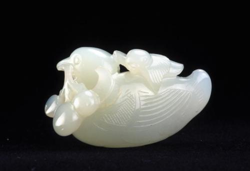 Pendant of a bird carrying a branch of fruit