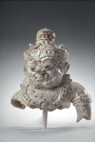 Head and torso of a crowned guardian