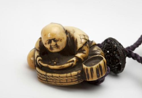 Netsuke of man with turtle in bowl
