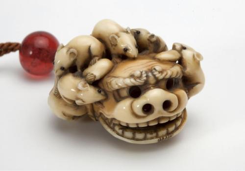 Netsuke of rats crawling on lion mask and drum
