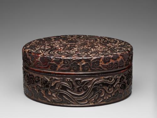 Round box with design of dragons playing amid clouds