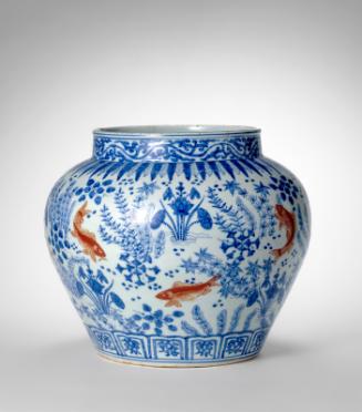 Jar with fish in lotus pond
