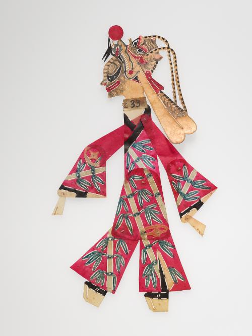 Tiger-faced figure in red robe with bamboo design and pheasant-feathered headdress