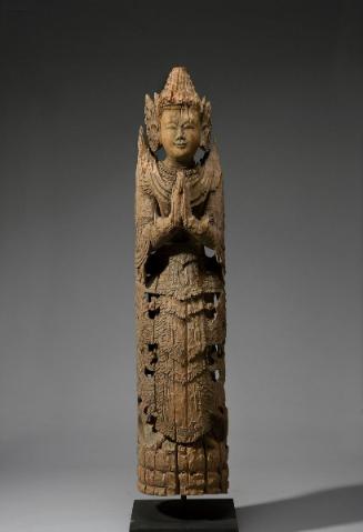 Crowned deity in a position of respect
